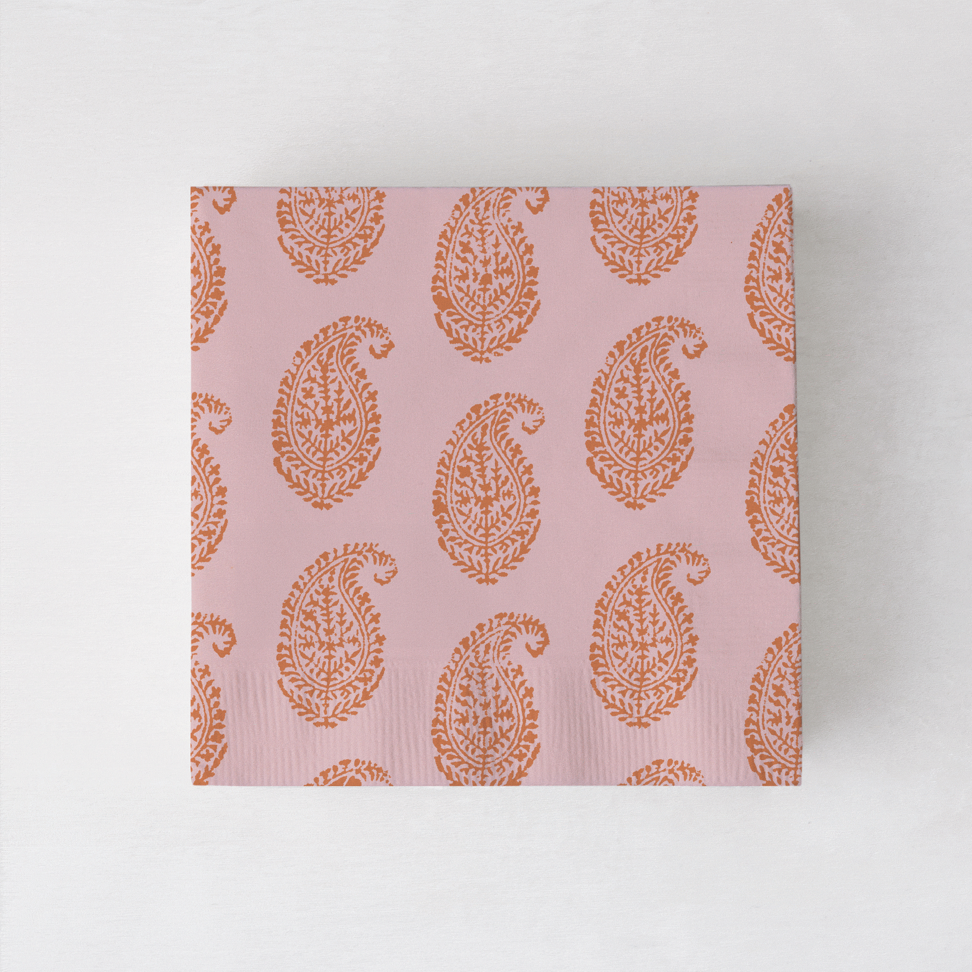 Peter Dunham + Hudson Grace Orange Kashmir cocktail napkins with paisley print.