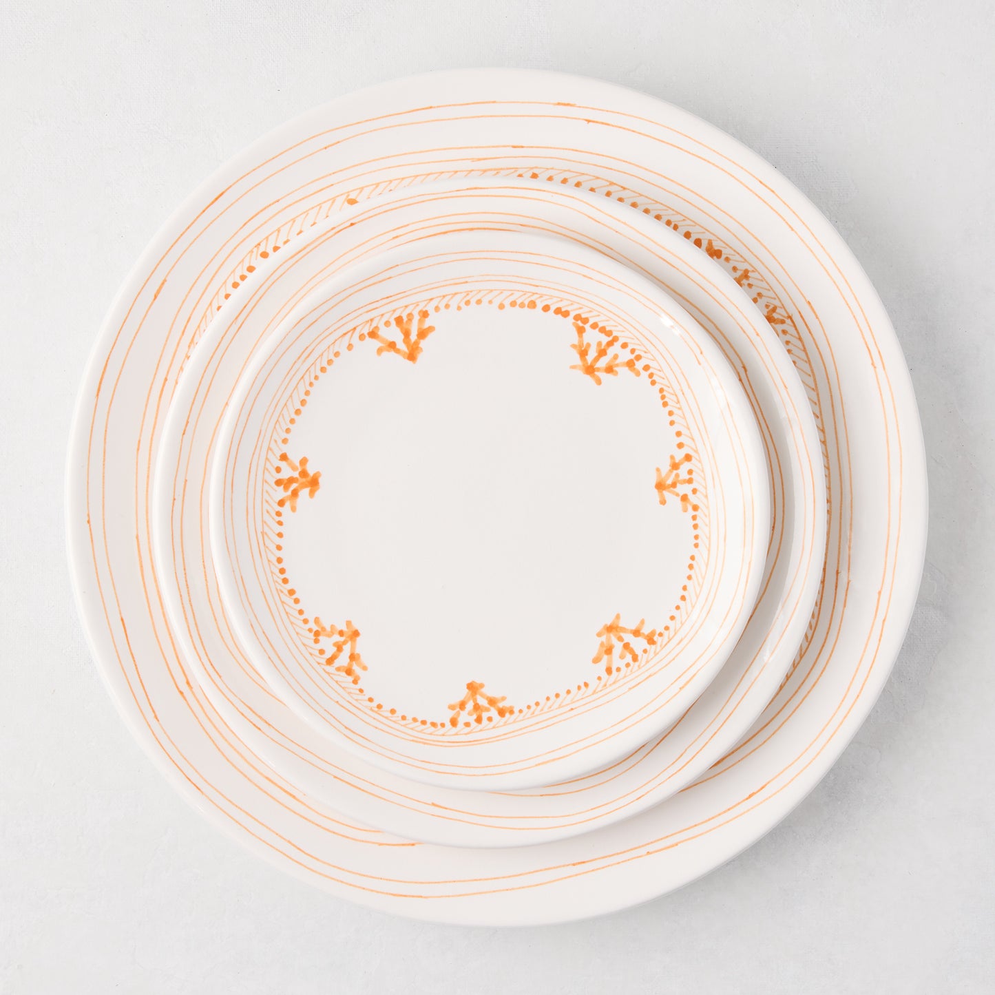 White Peter Dunham + Hudson Grace Orange Fez hand-painted border appetizer plate, top-down view.