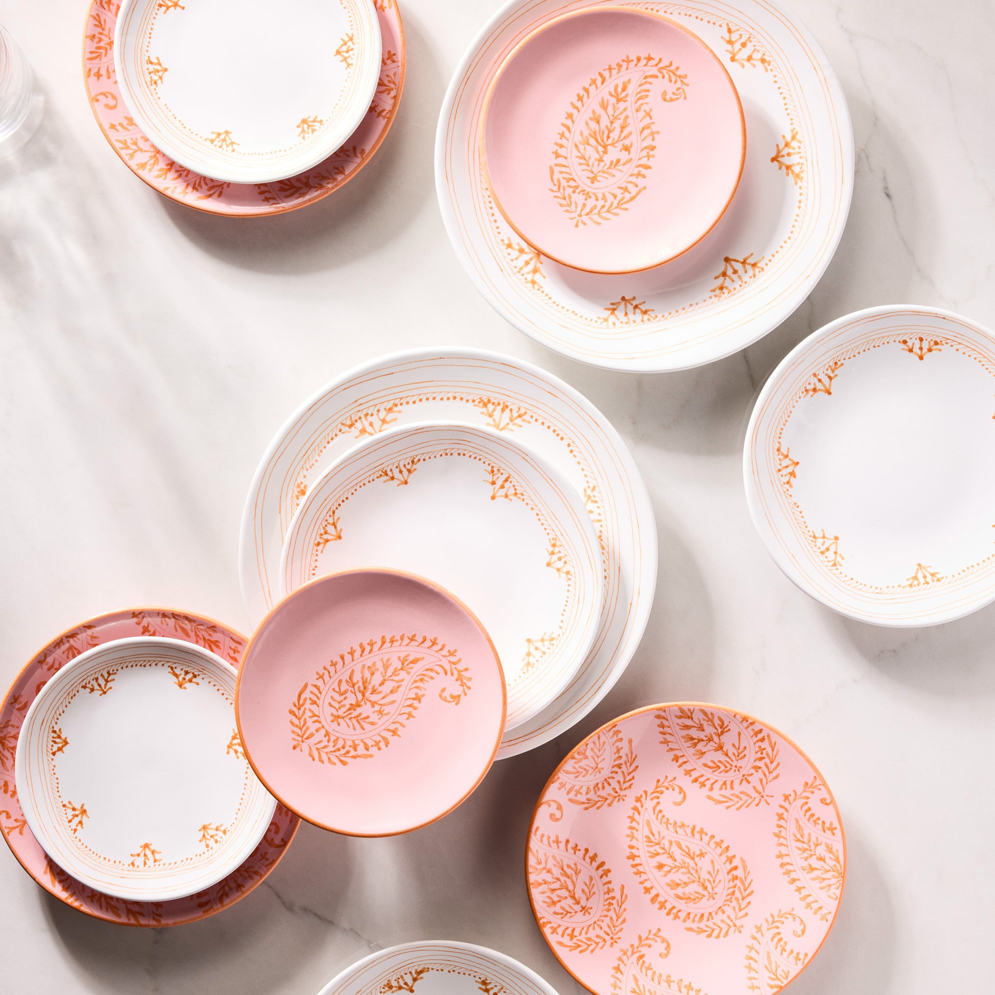 Peter Dunham + Hudson Grace Orange Fez hand-painted border dinner plates in white and pink.