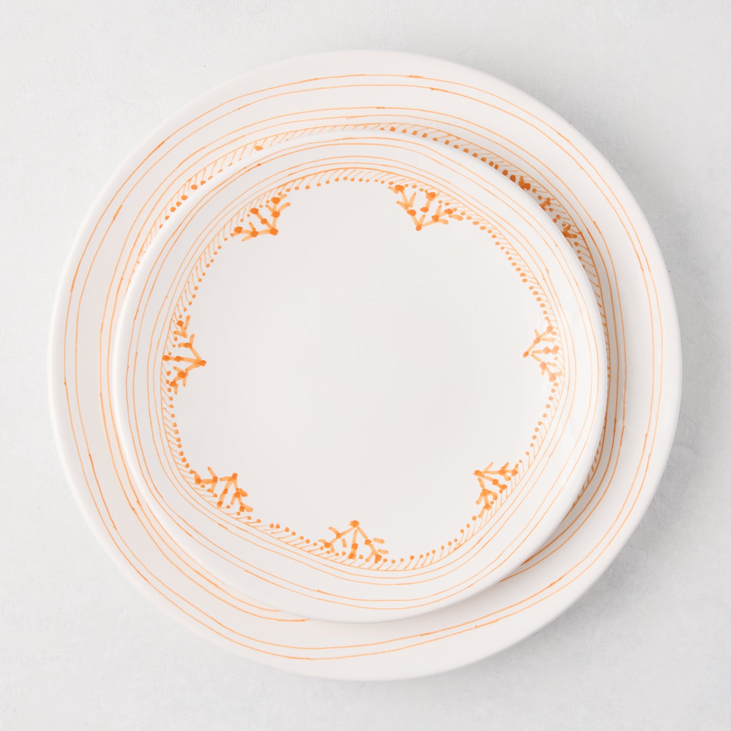 Peter Dunham + Hudson Grace Orange Fez hand-painted border dinner plate, white with orange patterns.