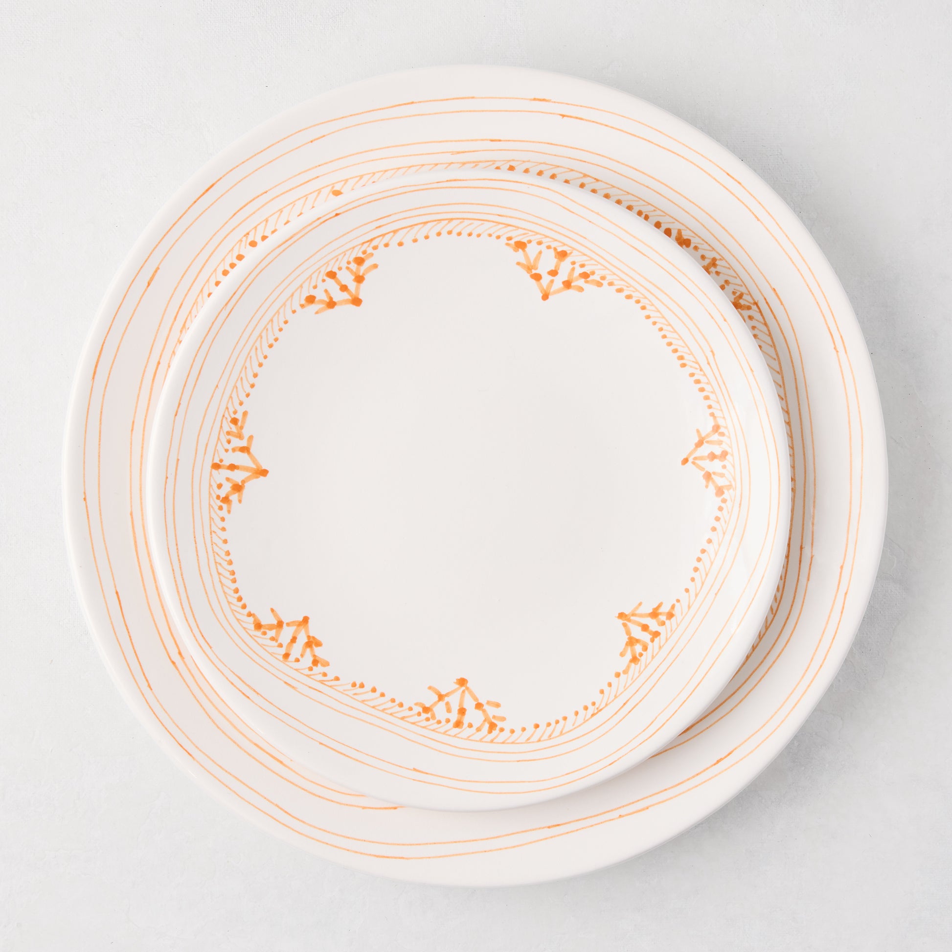Peter Dunham + Hudson Grace Orange Fez hand-painted border dinner plate, white with orange patterns.