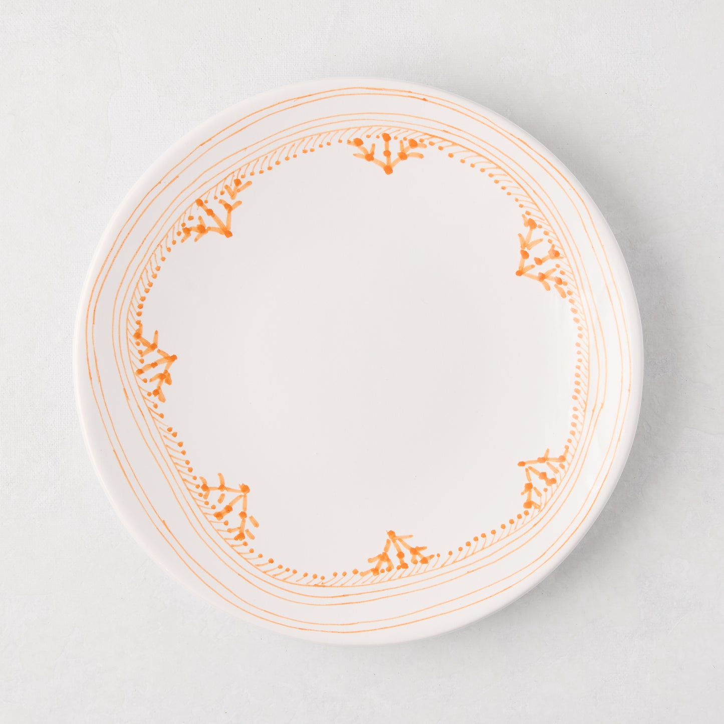 Peter Dunham + Hudson Grace Orange Fez hand-painted salad plate with an orange patterned border.