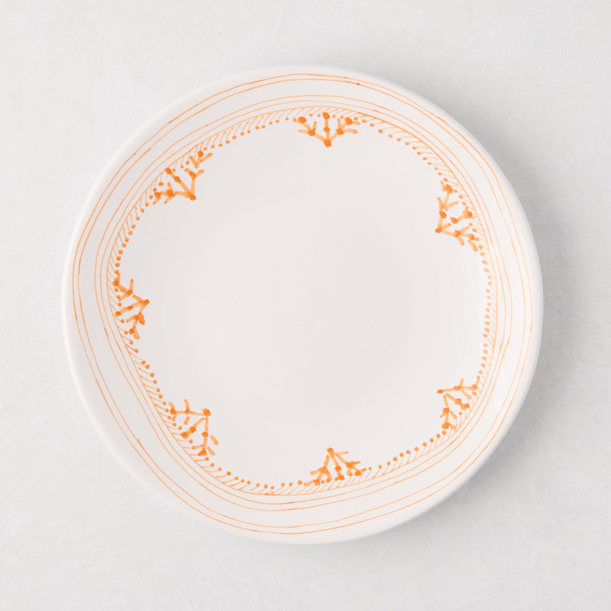 Peter Dunham + Hudson Grace Orange Fez hand-painted salad plate with an orange patterned border.