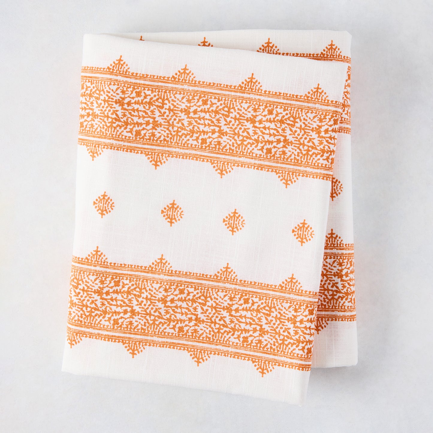 Peter Dunham + Hudson Grace Orange Fez Stripe printed tablecloth, 100% cotton slub, folded.