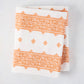Peter Dunham + Hudson Grace Orange Fez Stripe printed tablecloth, 100% cotton slub, folded.