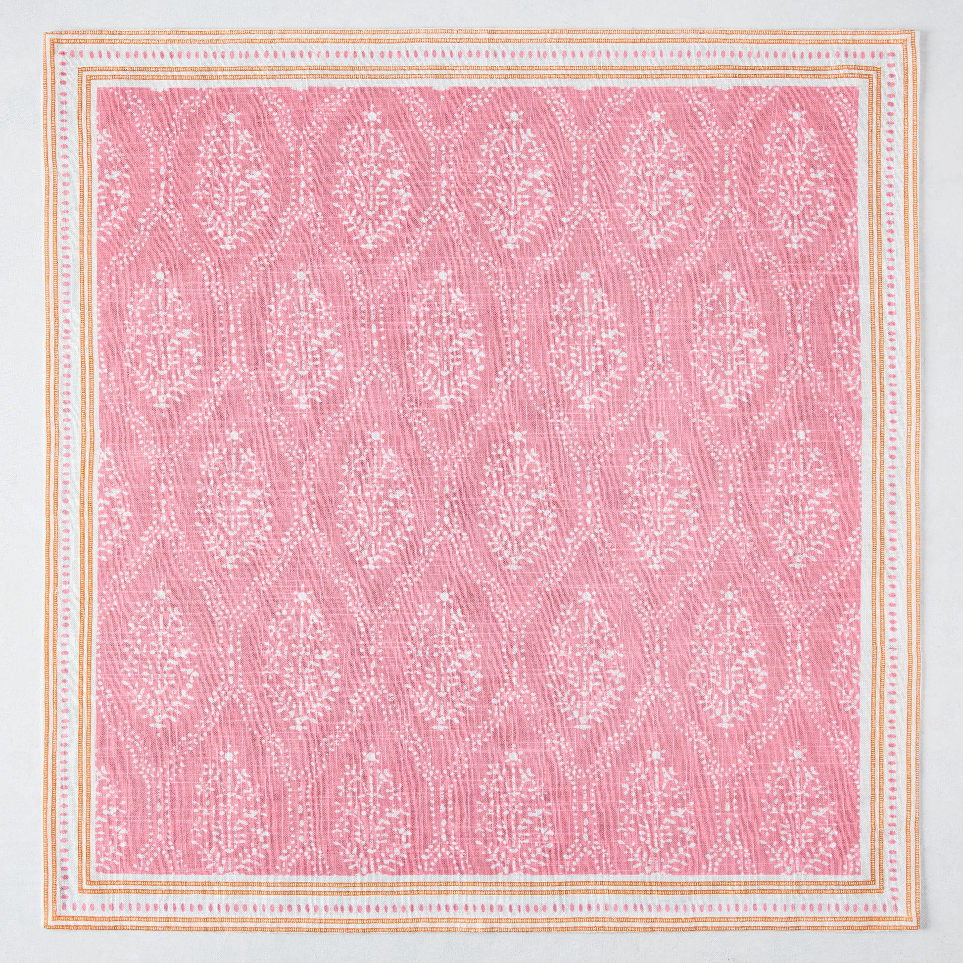 Pink Jaali printed cotton slub napkin with white floral pattern and orange border.