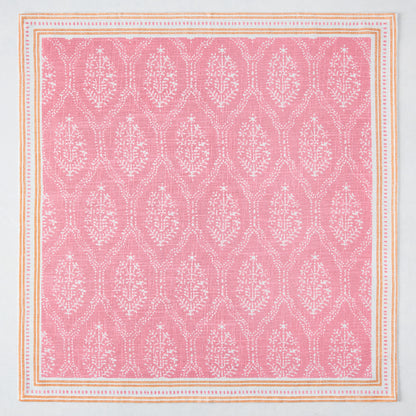 Pink Jaali printed cotton slub napkin with white floral pattern and orange border.