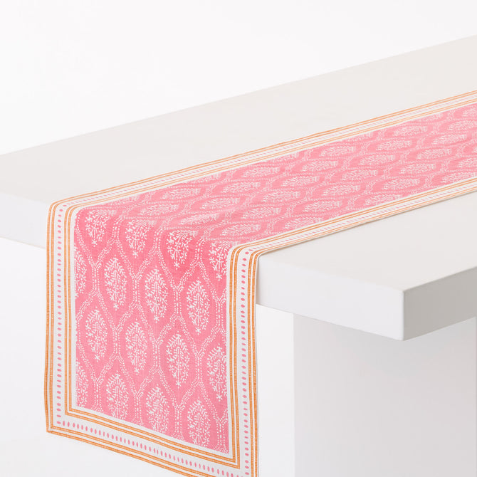 Pink Jaali printed cotton table runner with orange border, 108-inch length, featuring a graphic floral block print design.
