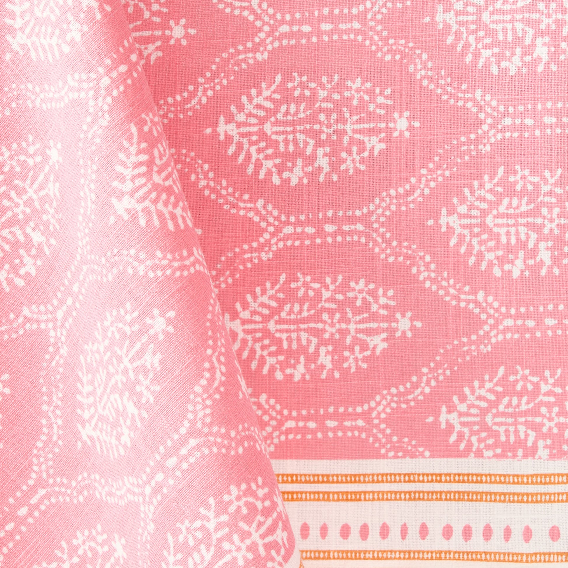 Pink Jaali printed cotton slub tablecloth with white floral patterns and an orange border.
