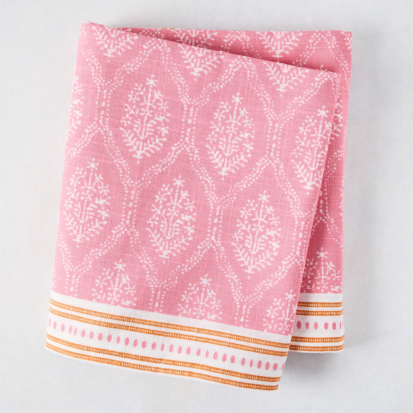 Pink Jaali Printed Tablecloth, 100% cotton slub, with white floral pattern and orange striped border.