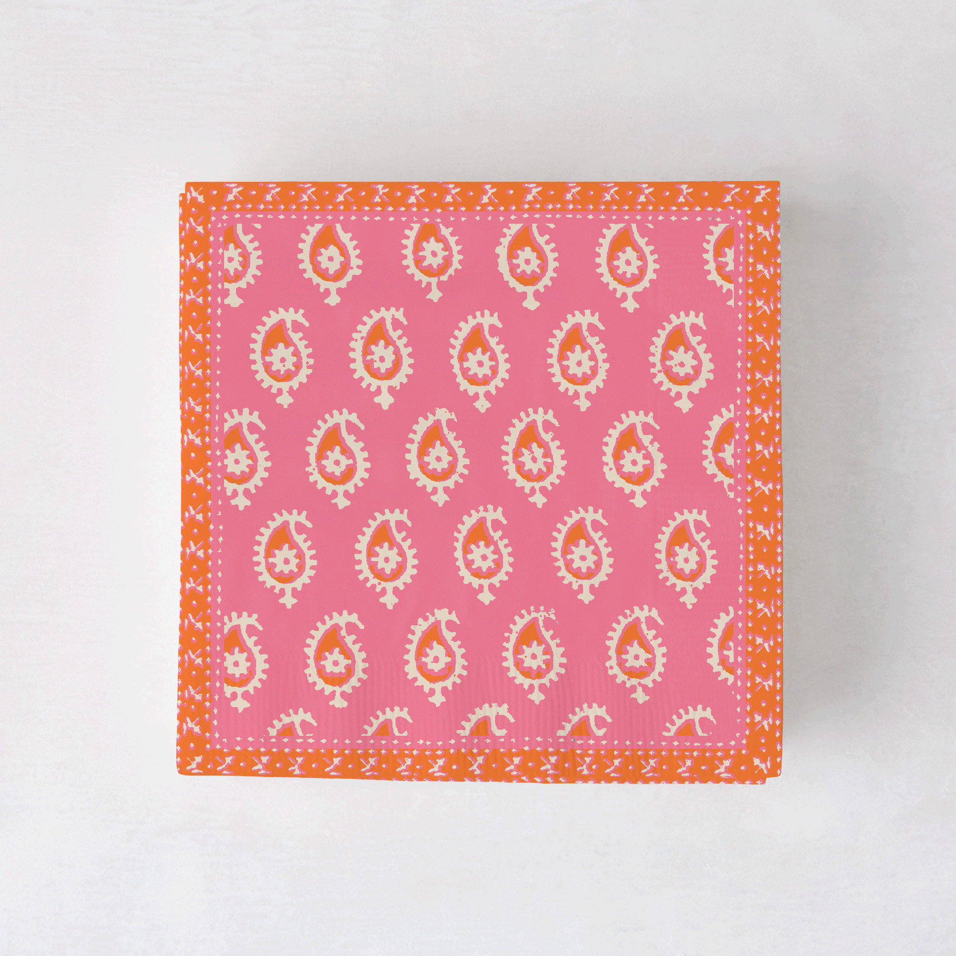 Peter Dunham + Hudson Grace Pink Janpath cocktail napkins with orange border and paisley pattern.