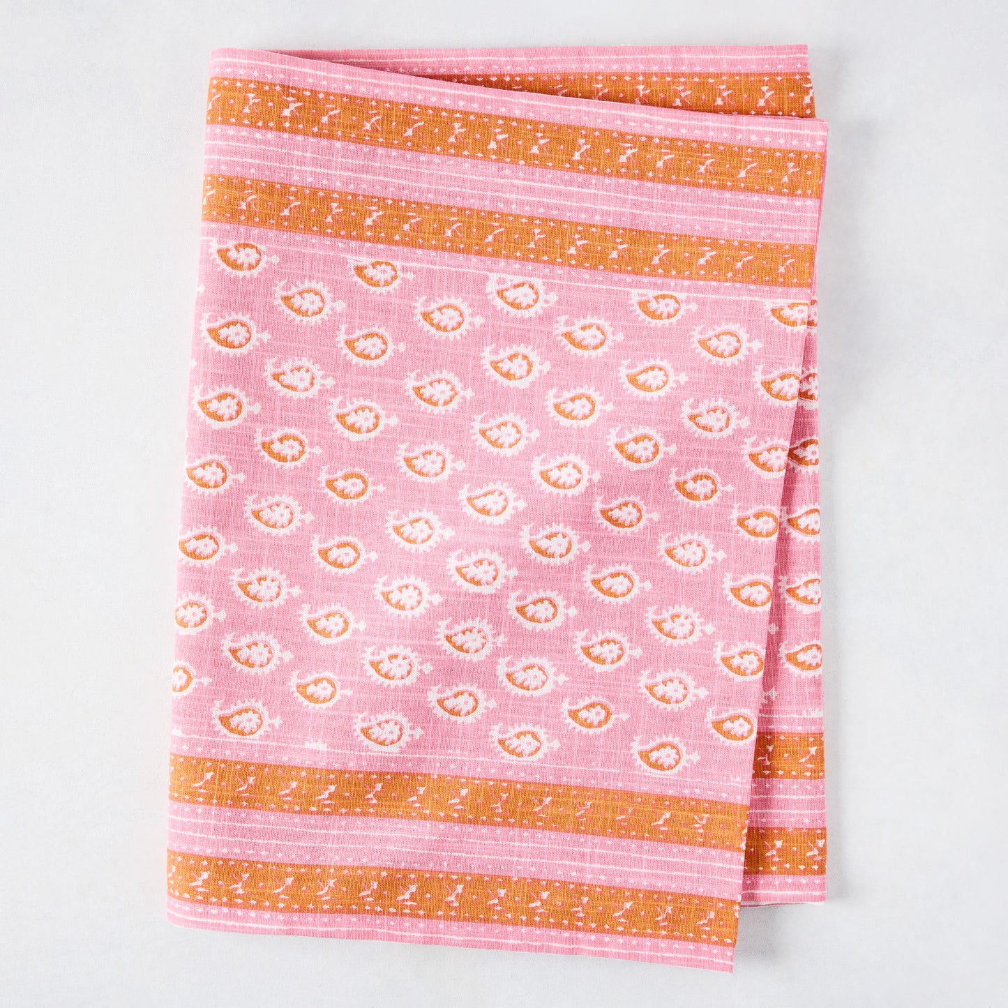 Pink Janpath Printed Table Runner, 100% cotton slub, with orange graphic border and small paisley pattern.