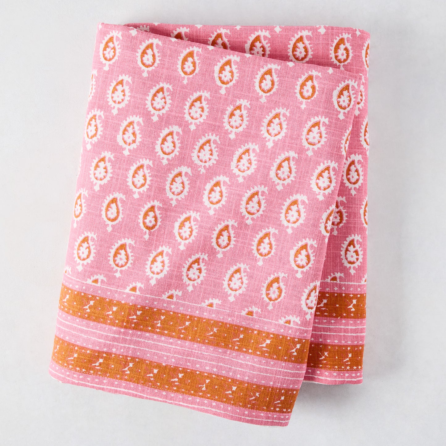 Pink Janpath Printed Tablecloth by Peter Dunham + Hudson Grace, 100% cotton slub, with paisley pattern and orange border.
