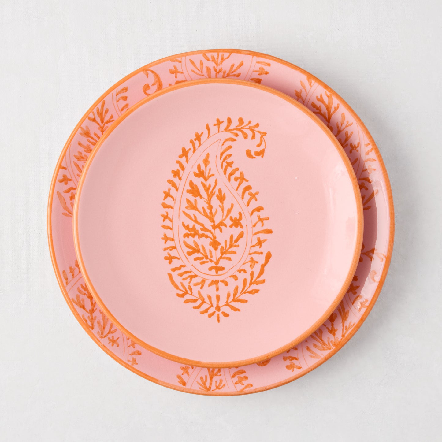 Peter Dunham + Hudson Grace Pink Kashmir hand-painted paisley salad plate with orange design.