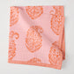 Pink Kashmir Paisley Printed Napkin by Peter Dunham + Hudson Grace, folded with orange paisley print.