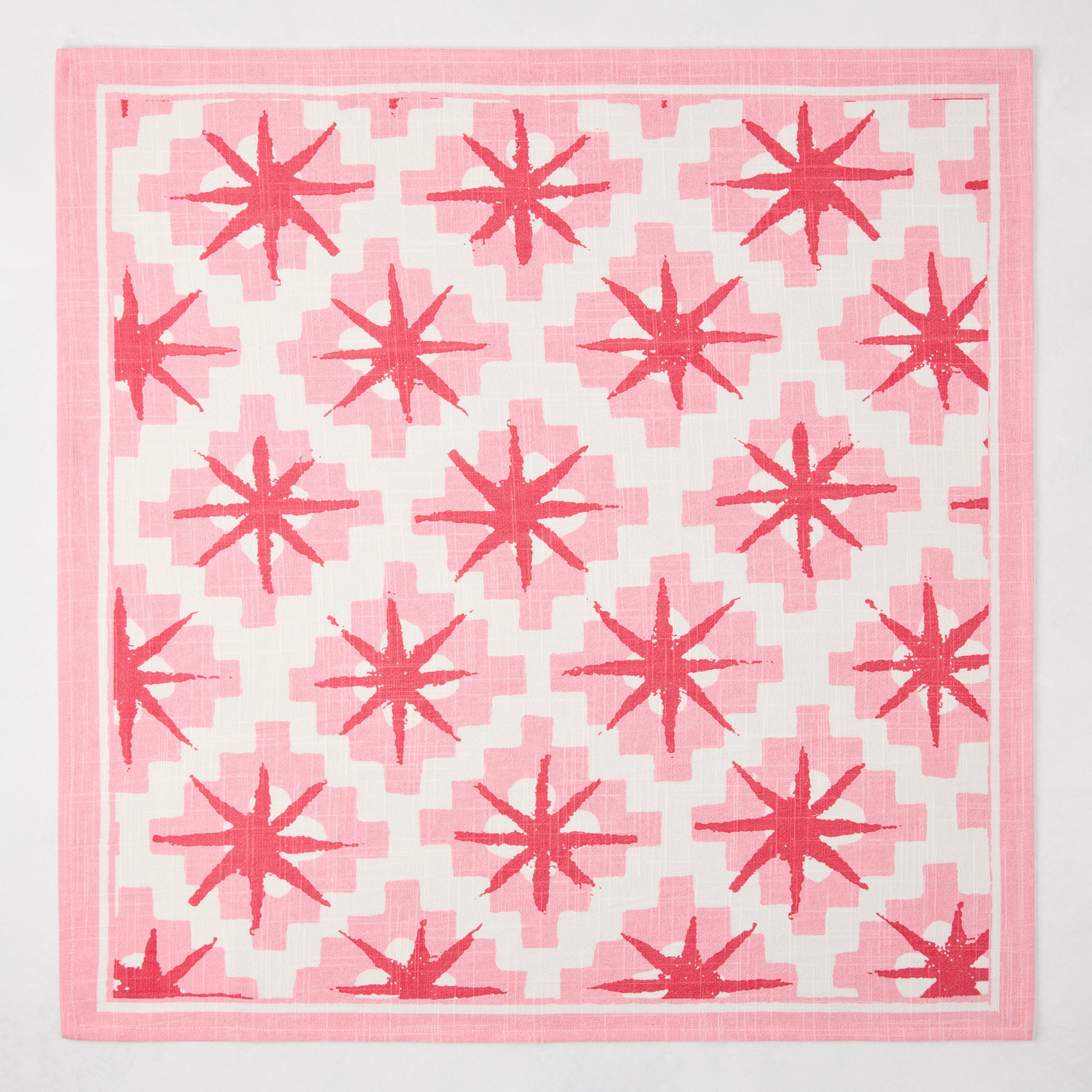 Peter Dunham + Hudson Grace Pink Starburst Printed Napkin, 100% cotton slub with red starburst pattern.