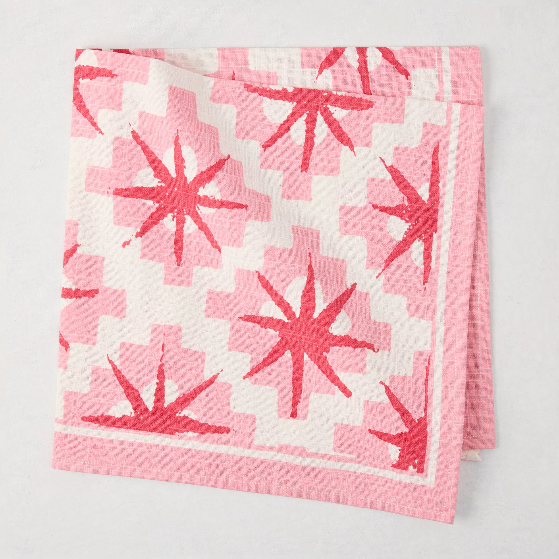 Peter Dunham + Hudson Grace Pink Starburst Printed Napkin, 100% cotton slub, folded.
