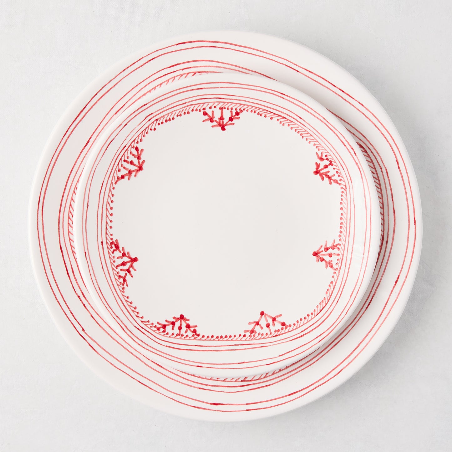 Peter Dunham + Hudson Grace Red Fez hand-painted white dinner plate with red border pattern.