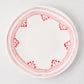 White dinner plate with a hand-painted red Fez border design.