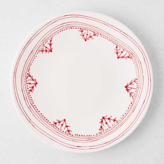 White dinner plate with a hand-painted red Fez border design.