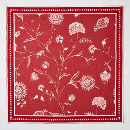 Red Indian Chintz cotton slub napkin with white floral pattern and dotted border.