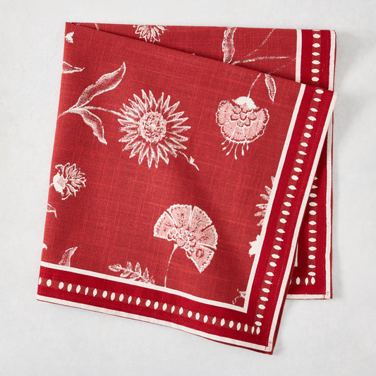 Red Indian Chintz cotton slub napkin with white floral print and dotted border.