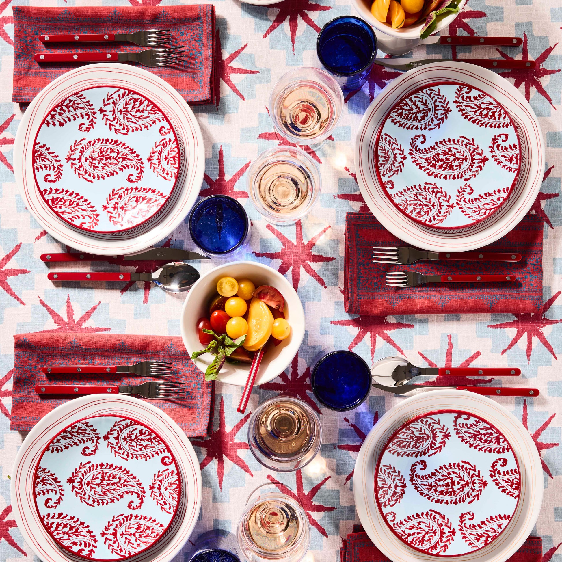 Peter Dunham + Hudson Grace Red Kashmir hand-painted paisley salad plates on a patterned table setting.