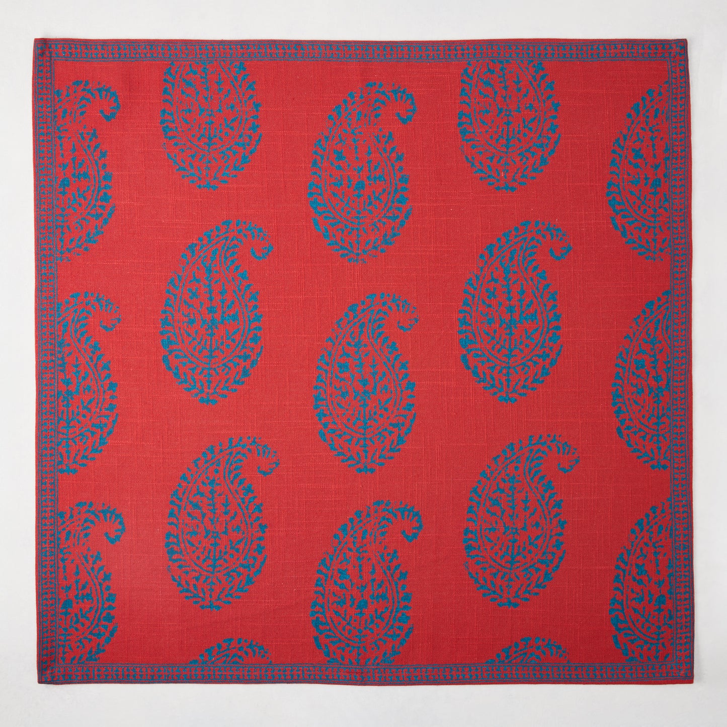Red Kashmir Paisley Printed Napkin by Peter Dunham + Hudson Grace, featuring blue paisley pattern and border.
