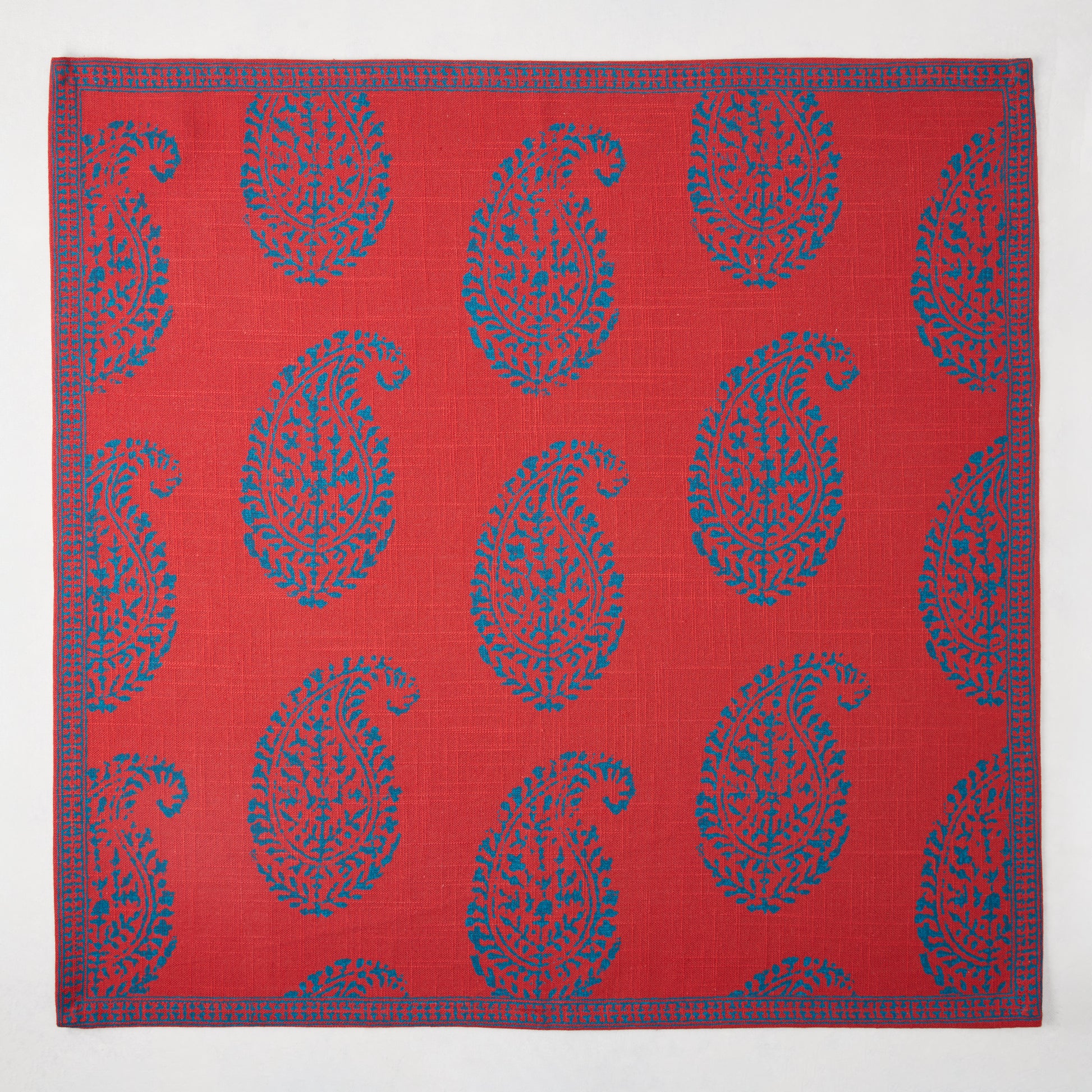 Red Kashmir Paisley Printed Napkin by Peter Dunham + Hudson Grace, featuring blue paisley pattern and border.