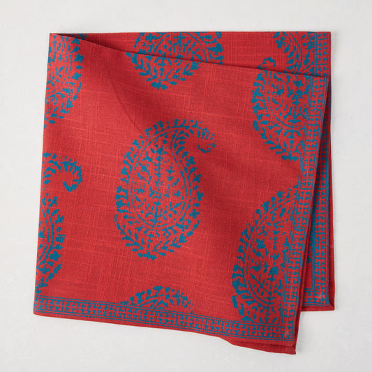 Red Kashmir Paisley Printed Napkin by Peter Dunham + Hudson Grace, folded with blue paisley pattern.