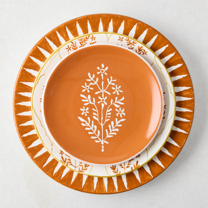 Peter Dunham + Hudson Grace Spice Orange Hand-Painted Sunburst Dinner Plate with smaller matching plates.