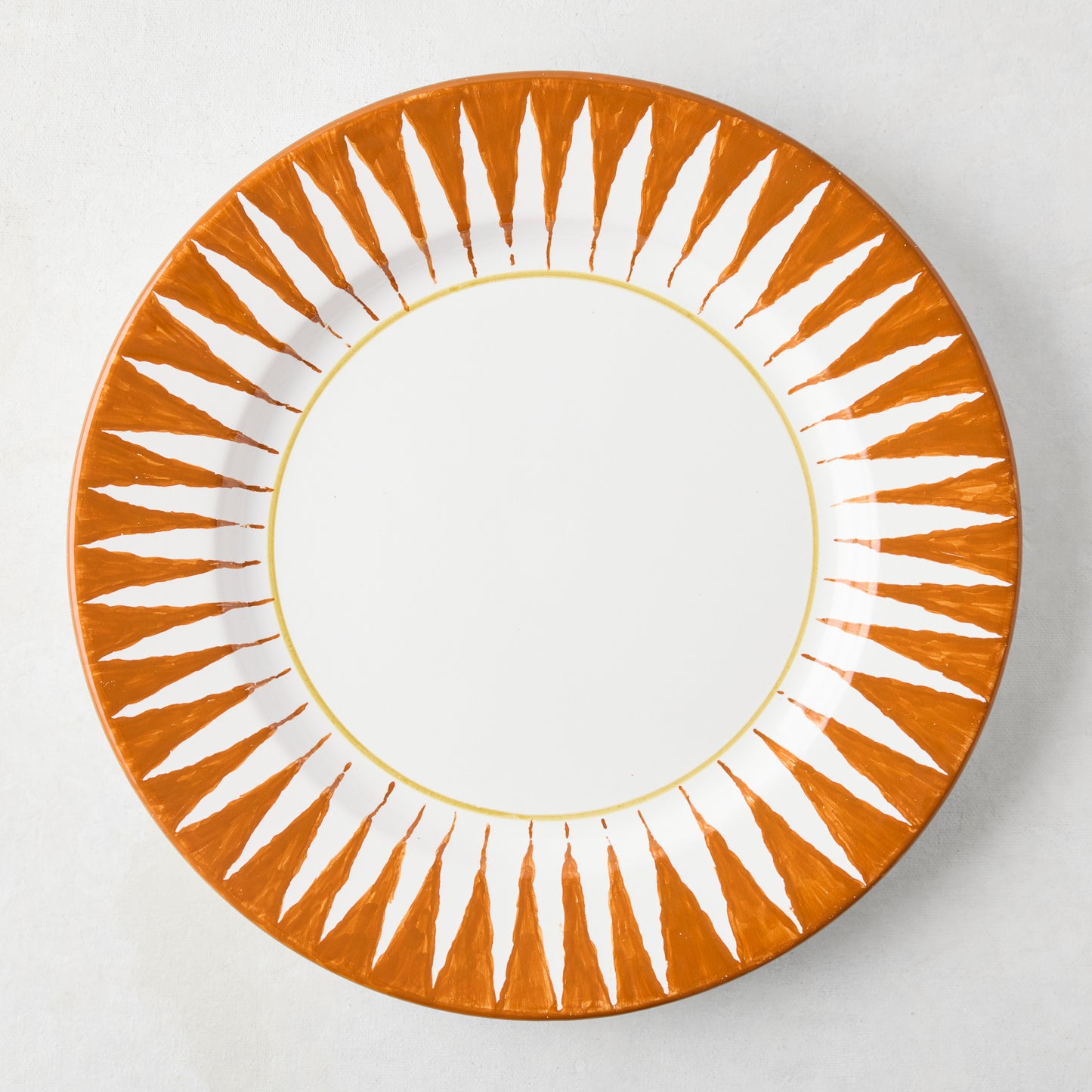 Peter Dunham + Hudson Grace Spice Orange Hand-Painted Sunburst Dinner Plate, white center, ikat stripe pattern.