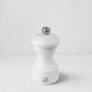 Peugeot Bistro 4" matte white wooden salt mill with a silver-toned finial.