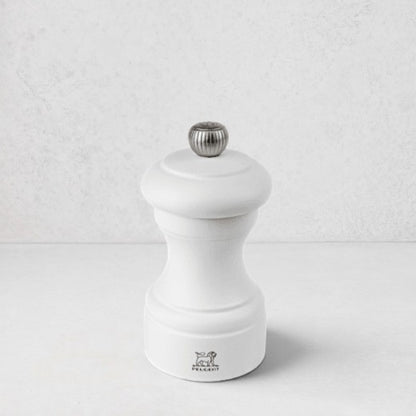 Peugeot Bistro 4" matte white wooden salt mill with a silver-toned finial.
