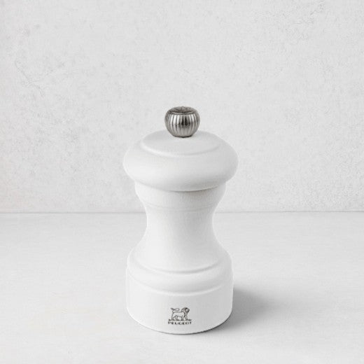 Peugeot Bistro 4" matte white wooden salt mill with a silver-toned finial.