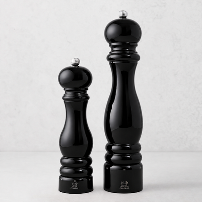 Peugeot Paris 9-inch salt and 12-inch pepper mills in glossy black lacquer finish with silver-tone metal knobs.