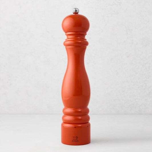 Peugeot Paris Exclusive 12" pepper mill in International Orange beechwood with a silver finial.