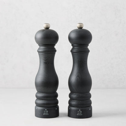 Two Peugeot Paris matte black 9" wooden salt mills with silver tops.