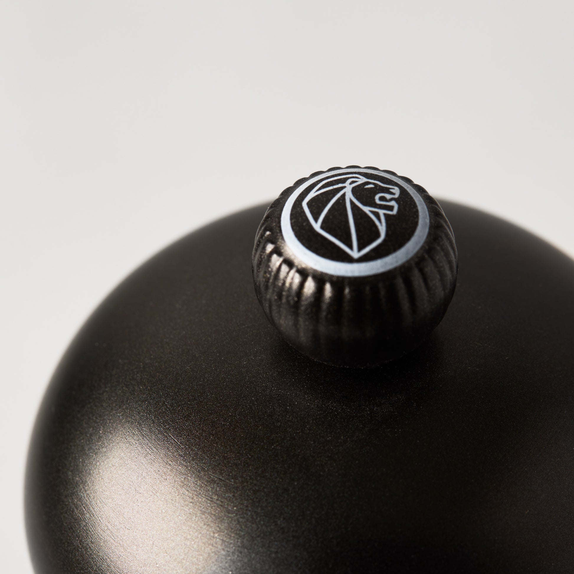 Peugeot Paris Matte Black 9" Salt Mill, close-up of the top with lion logo.