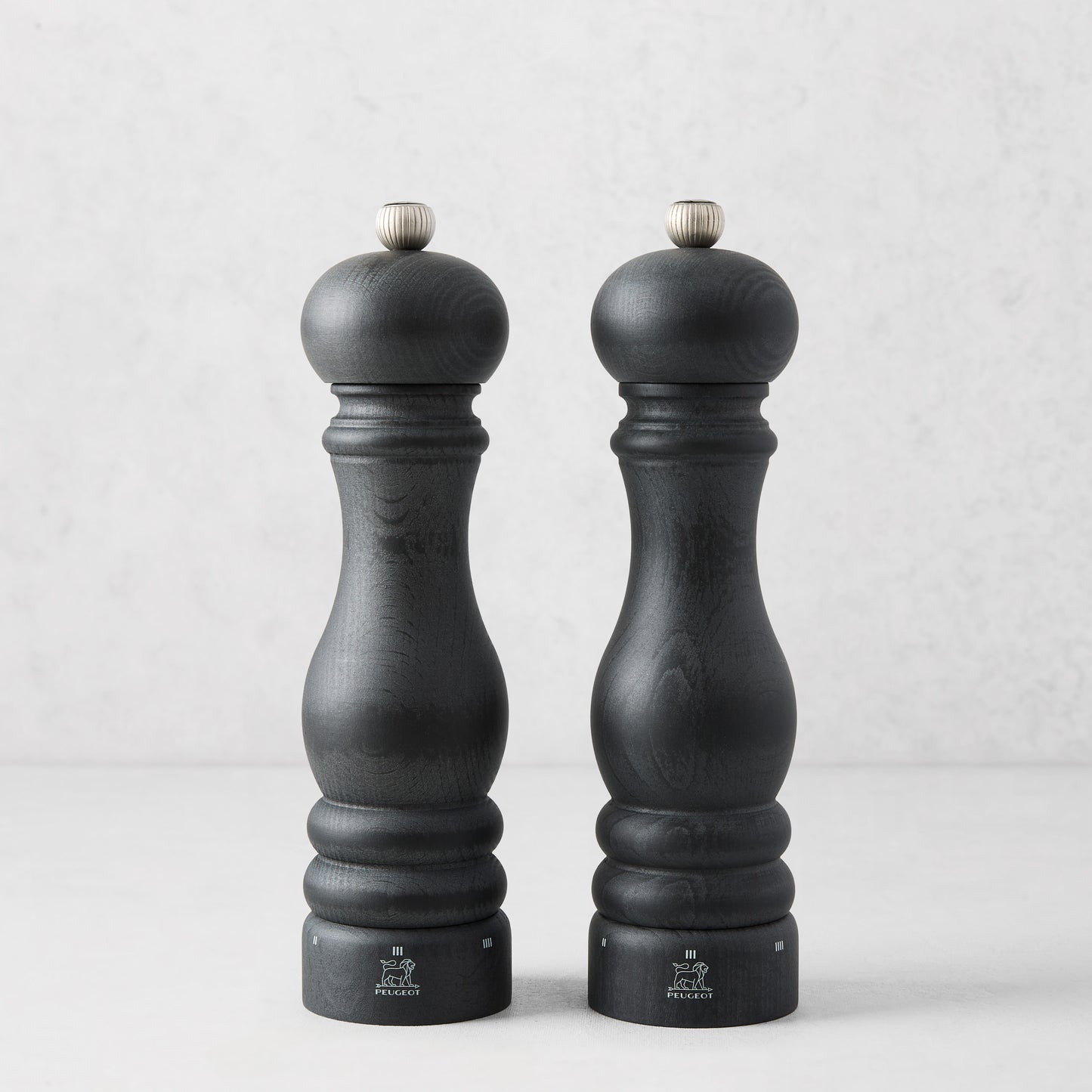 Peugeot Paris Matte Black 9" wood salt and pepper mills set with silver top knobs.