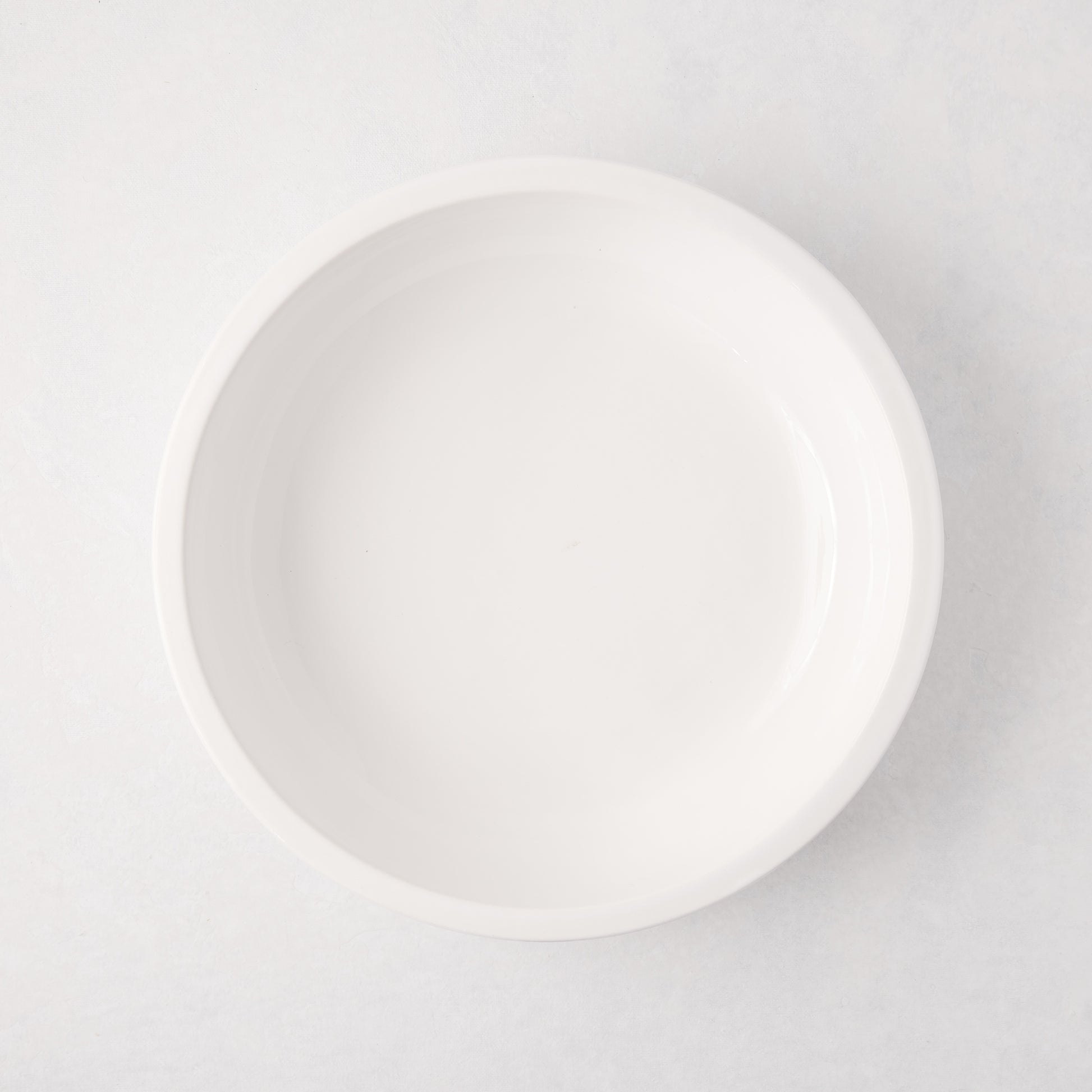 White ceramic Piatto Riso Small Serve Bowl, 11.75"Dia x 3"H, with a simple, sleek design.
