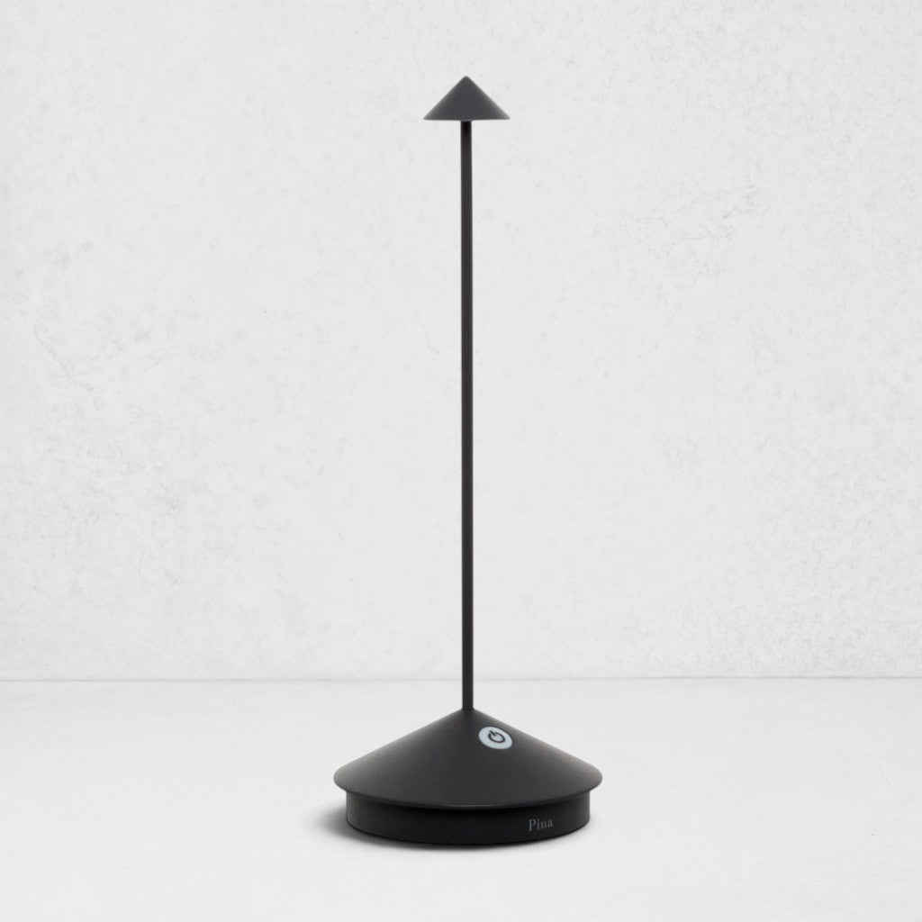 Pina Pro Black rechargeable LED lamp with a broad base, thin rod, and conical shade.