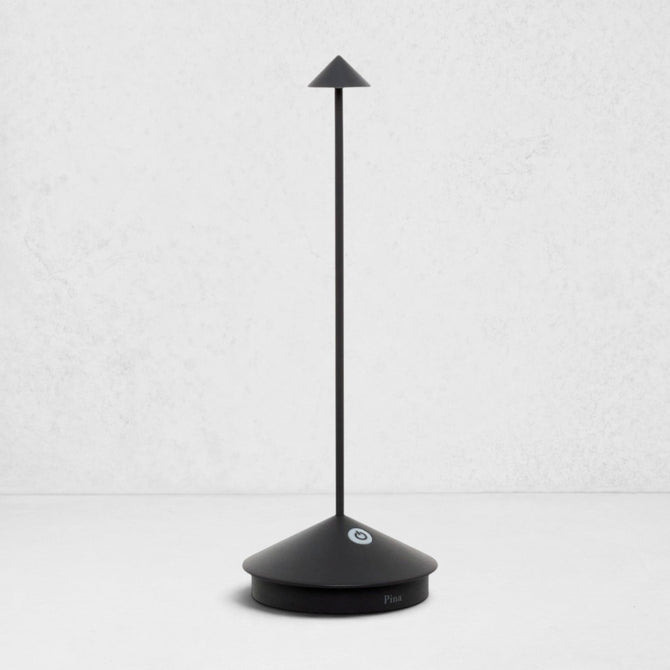Pina Pro Black rechargeable LED lamp with a broad base, thin rod, and conical shade.