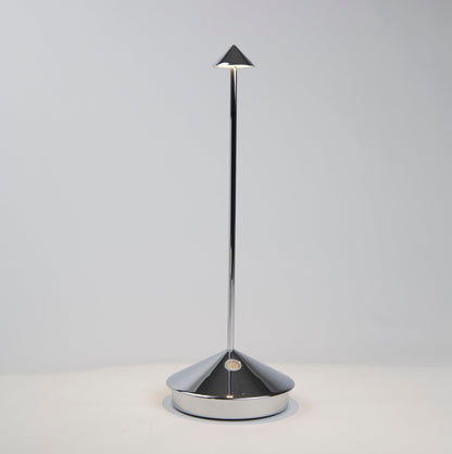 Pina Pro glossy chrome rechargeable LED lamp with a conical base and thin rod, emitting light from a small shade.