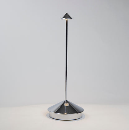 Pina Pro glossy chrome rechargeable LED lamp with a conical base and thin rod, emitting light from a small shade.