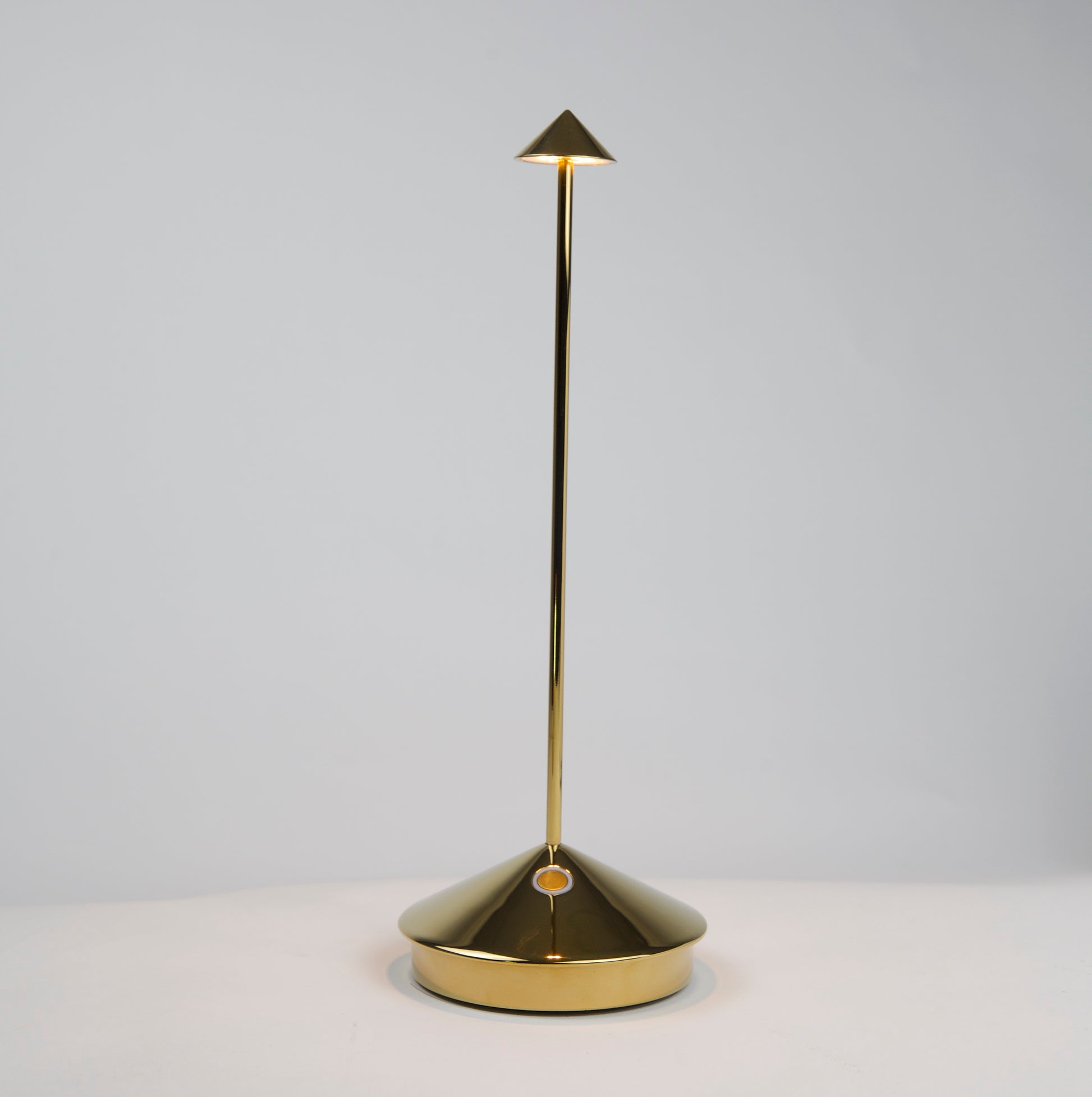 Pina Pro Glossy Gold rechargeable LED lamp with a conical base, thin rod, and triangular shade.