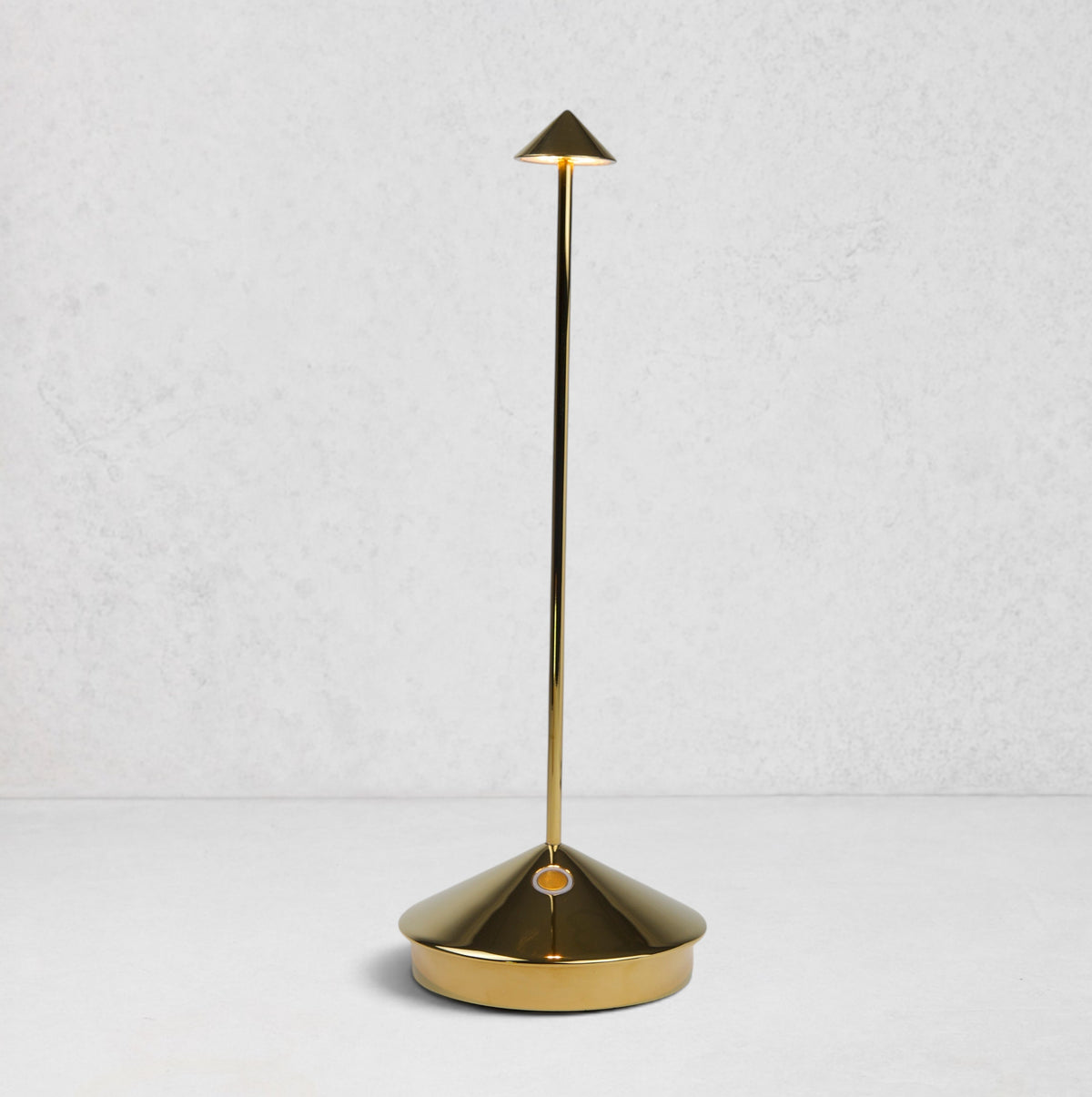 Pina Pro Glossy Gold rechargeable LED lamp with a conical base, thin rod, and triangular shade.