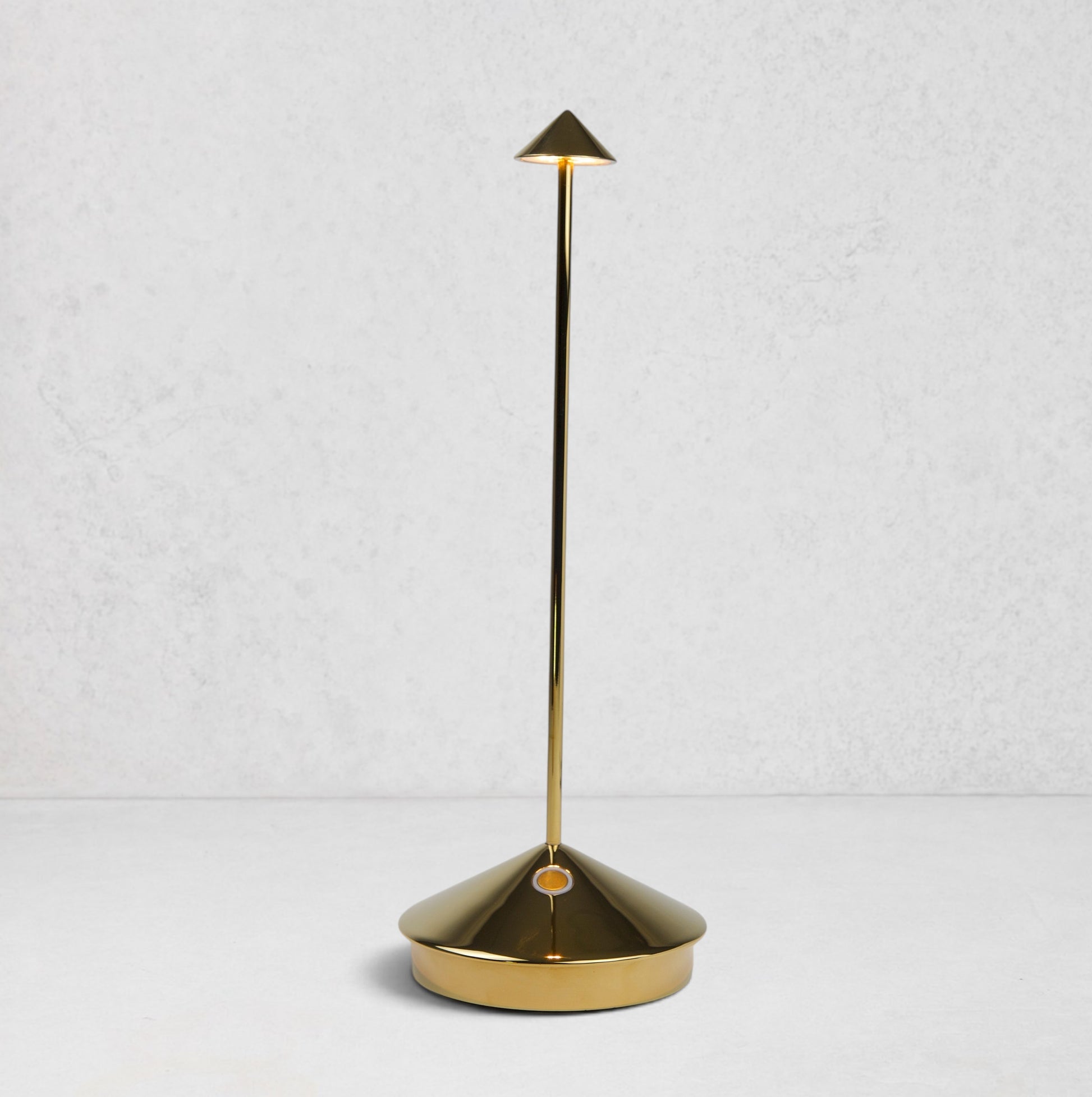 Pina Pro Glossy Gold rechargeable LED lamp with a conical base, thin rod, and triangular shade.