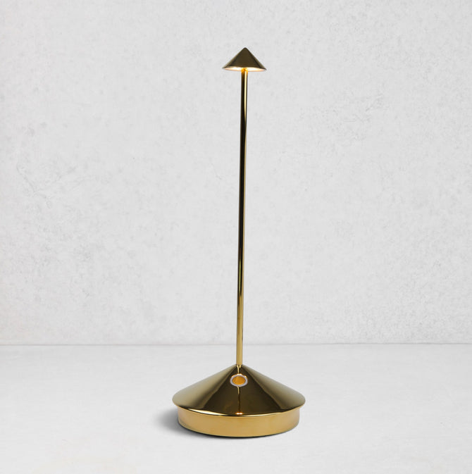Pina Pro Glossy Gold rechargeable LED lamp with a conical base, thin rod, and triangular shade.
