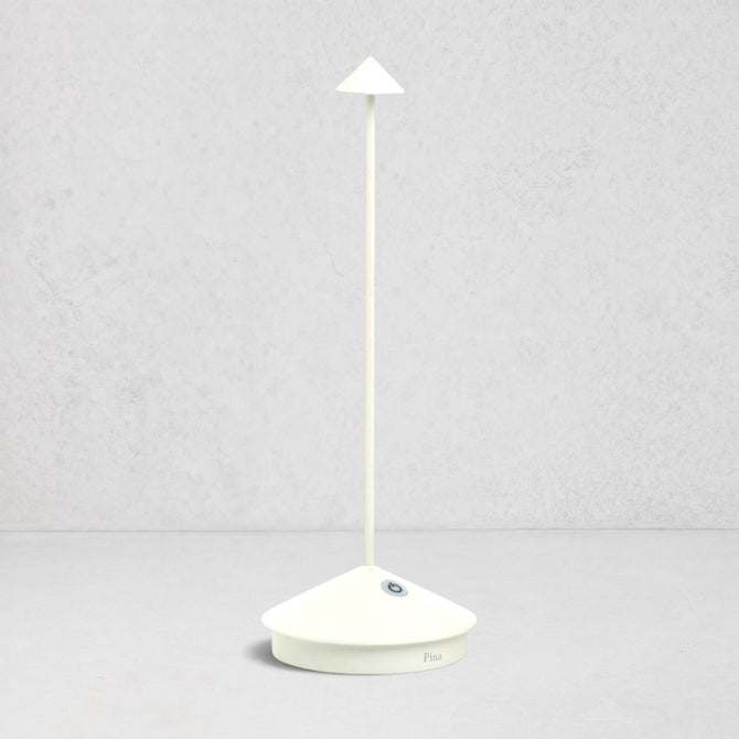 White die-cast aluminum Pina Pro rechargeable LED table lamp with a broad base and thin rod.
